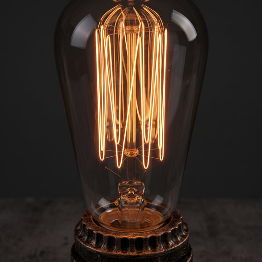Close-up of the Edison bulb in the industrial pipe desk lamp socket