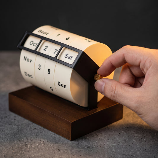 Rotating perpetual calendar angled view — minimal brushed metal design