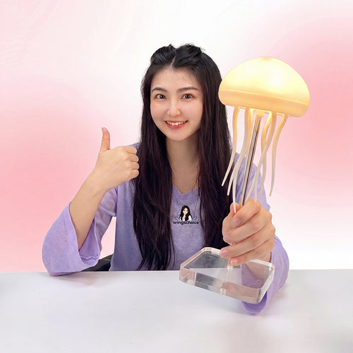 Haven& Jellyfish Ambient Mood Lamp glowing purple on bedside table