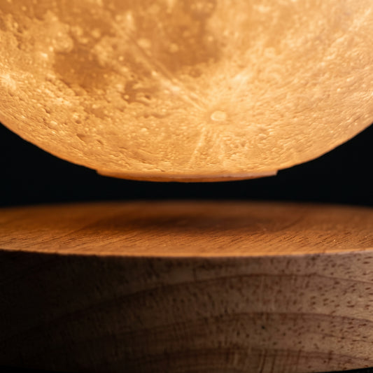 Close-up of the levitation gap — moon floating above the Floating Moon Lamp magnetic base