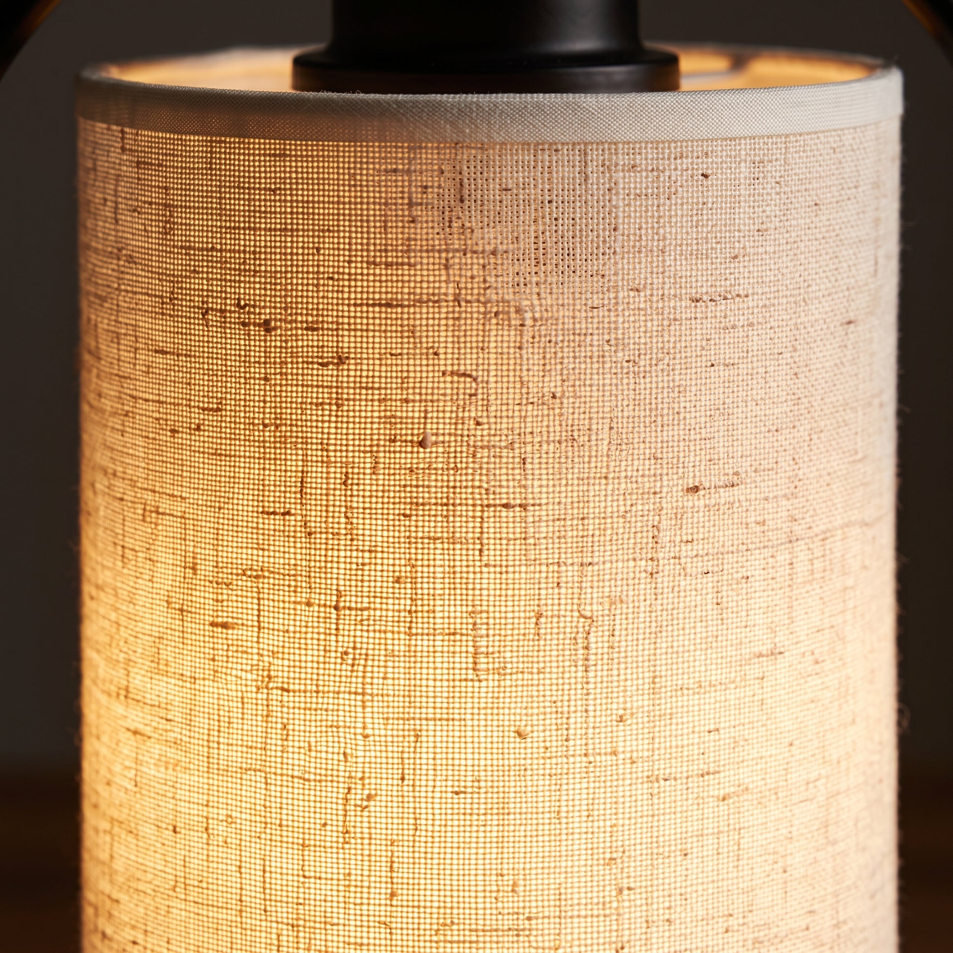 Close-up of the linen fabric shade on the minimalist bedside table lamp