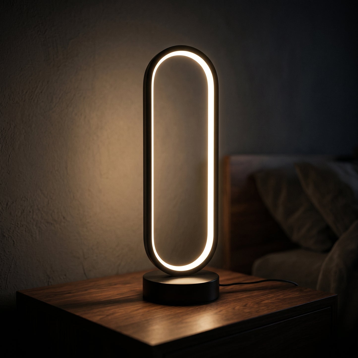 Halo ring lamp on a desk — slim circular black ring with soft LED halo glow