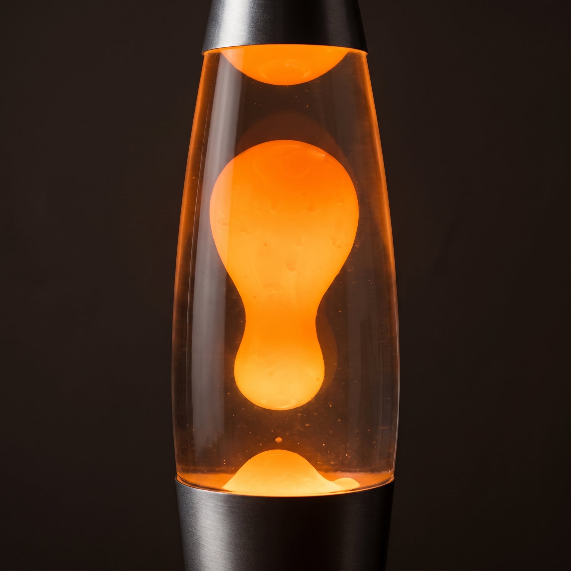 Volcano lava lamp tighter shot — tall glass cylinder with glowing red wax in motion