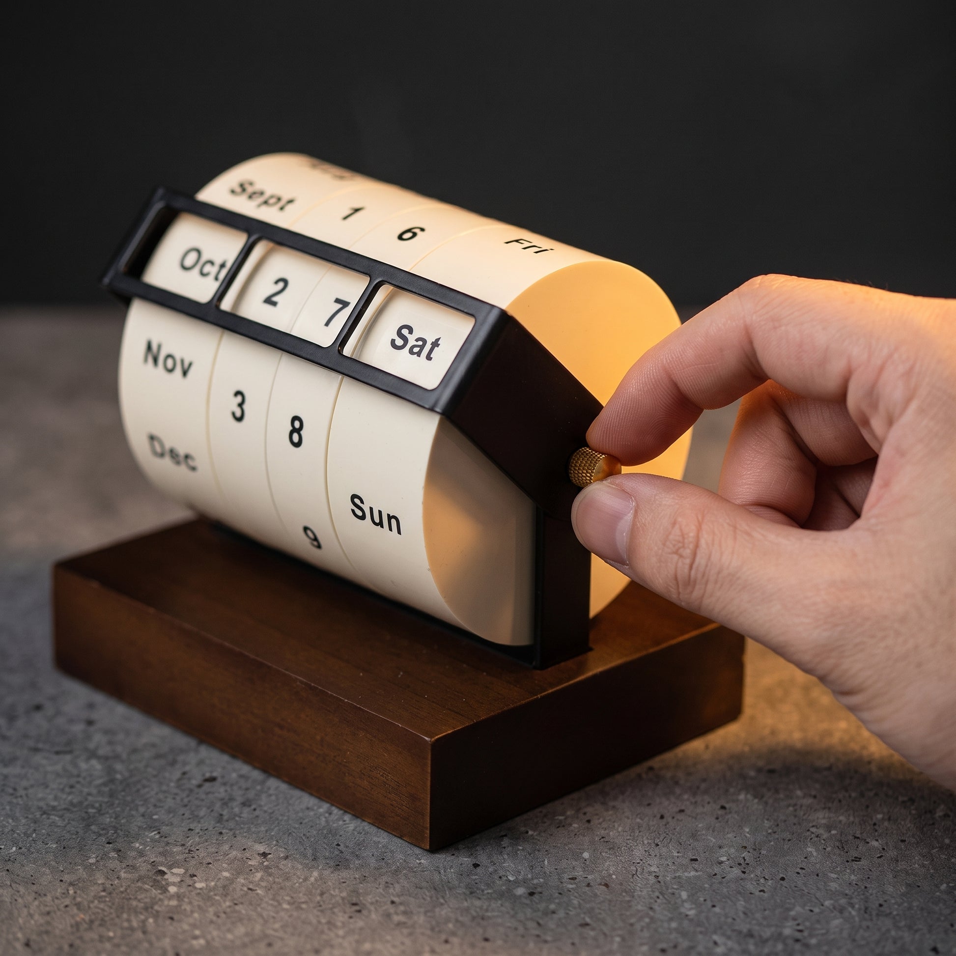Rotating perpetual calendar angled view — minimal brushed metal design