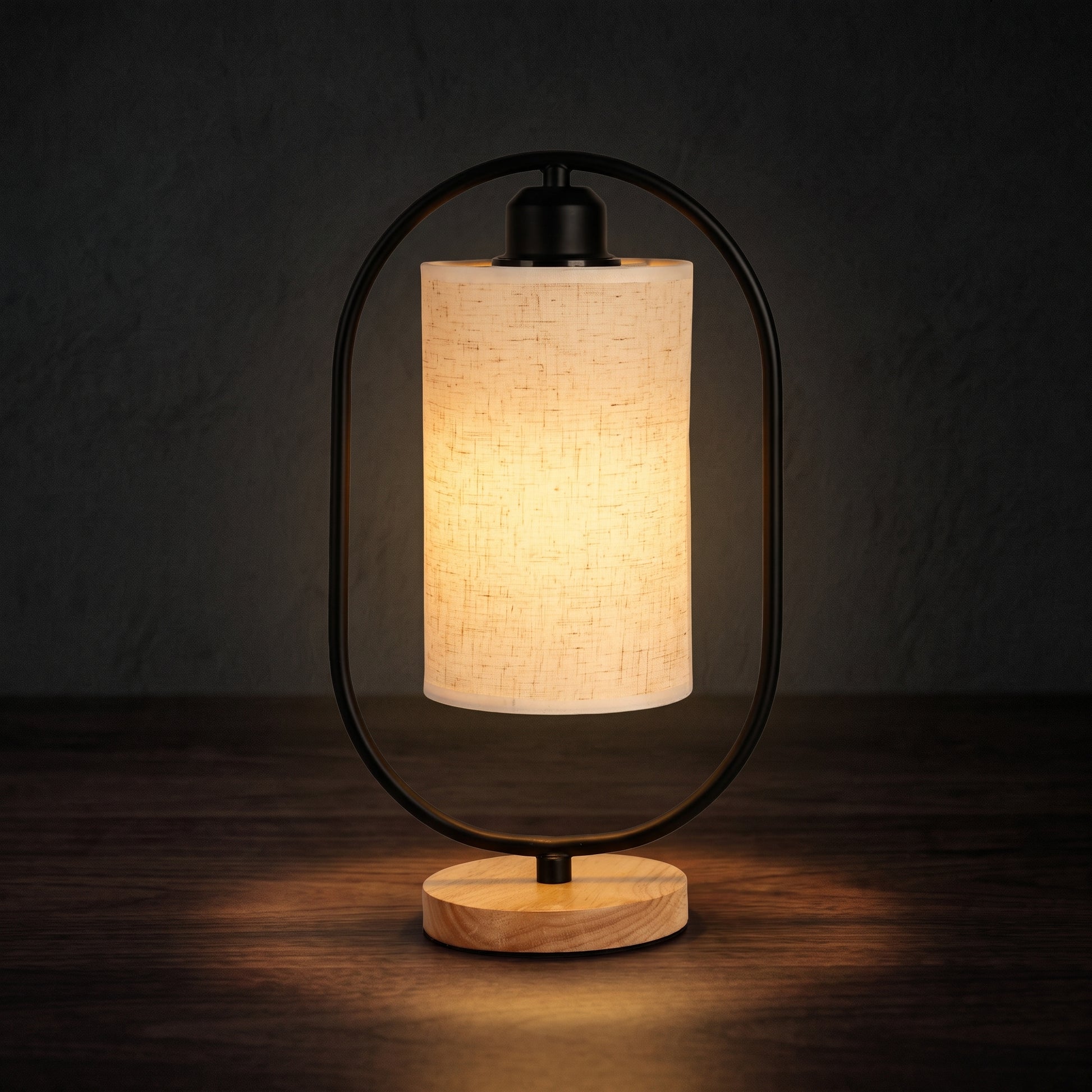 Minimalist bedside table lamp on a nightstand with warm LED glow in a dark bedroom
