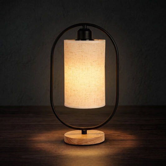 Minimalist bedside table lamp on a nightstand with warm LED glow in a dark bedroom