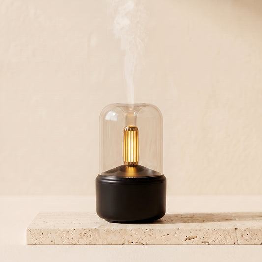 Candlelight aroma diffuser on a surface emitting warm mist with amber LED glow